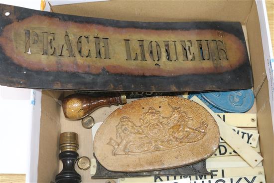 A collection of assorted cellar labels including ivorine and metal, five pierced metal stencils, a cast bronze plaque 17cm